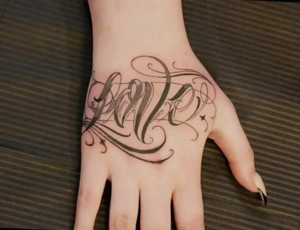 "Love" Script Hand Tattoo