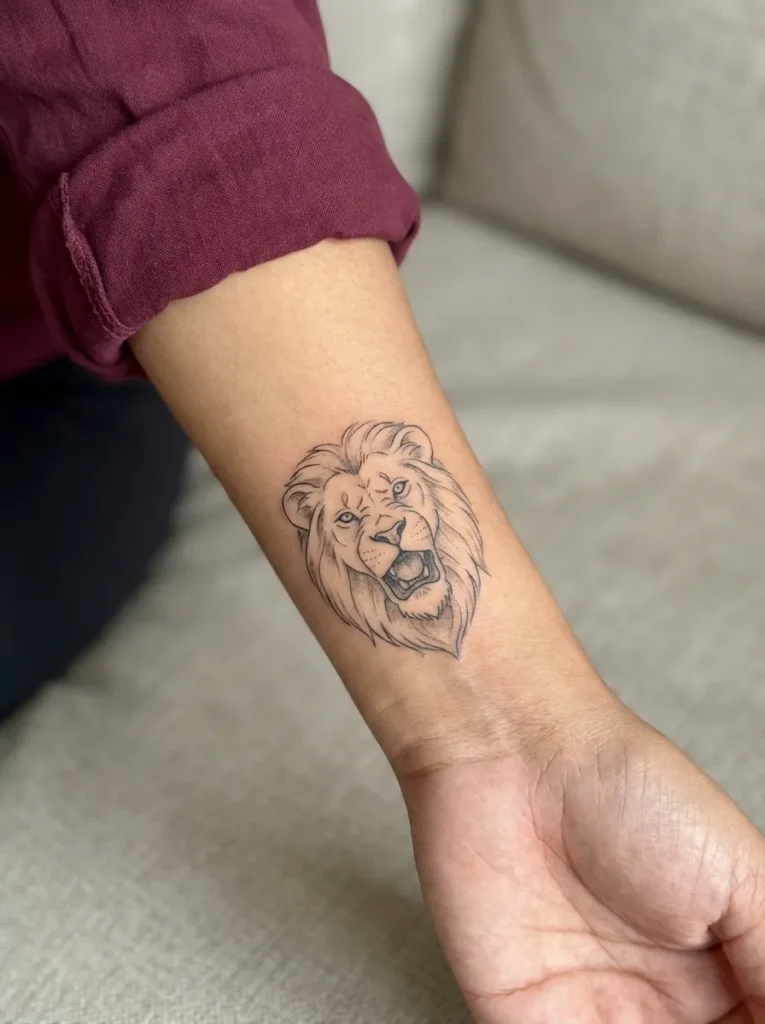 Lion Wrist Tattoo with Minimal Roar Detail