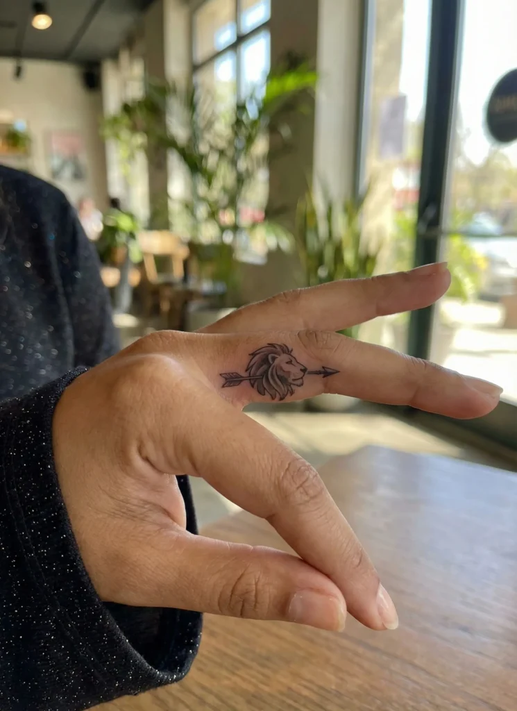 Lion with Arrow Finger Tattoo