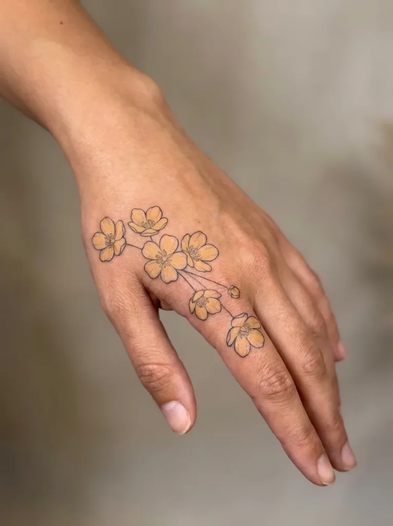 Buttercup Flower Hand Tattoo