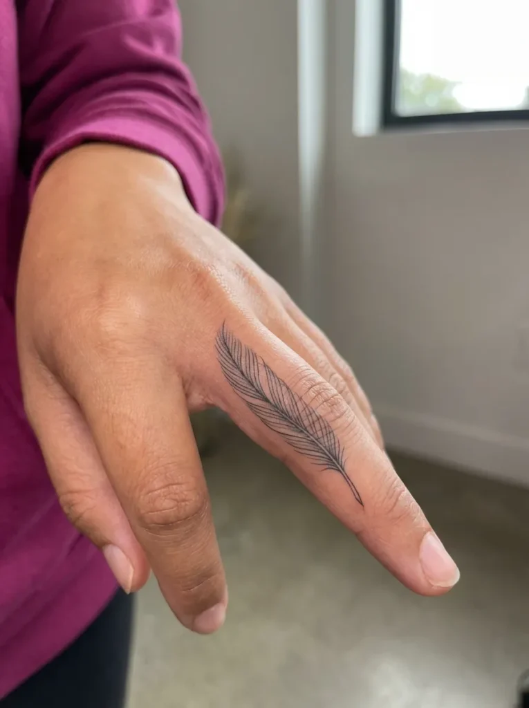 Minimal Feather Inner Finger Tattoo