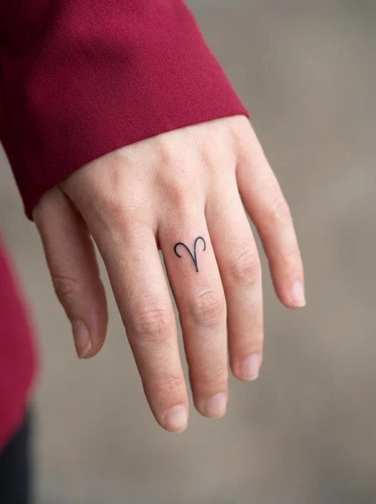 Minimal Zodiac Symbol Inner Finger Tattoo