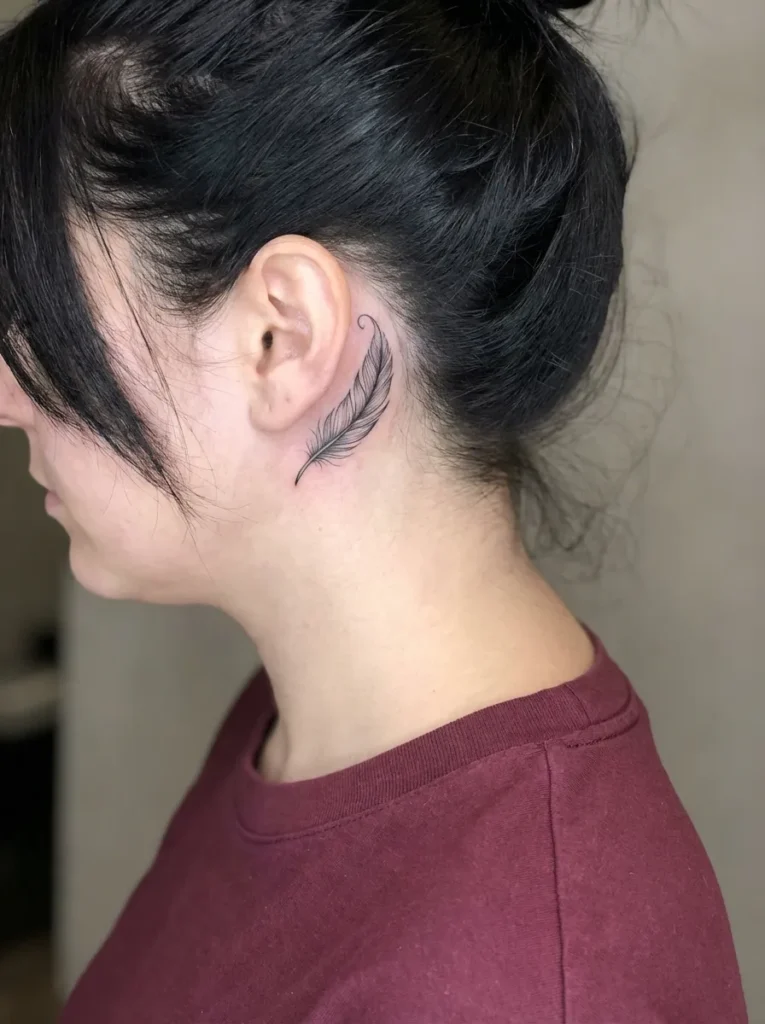 Small Feather Behind Ear Tattoo
