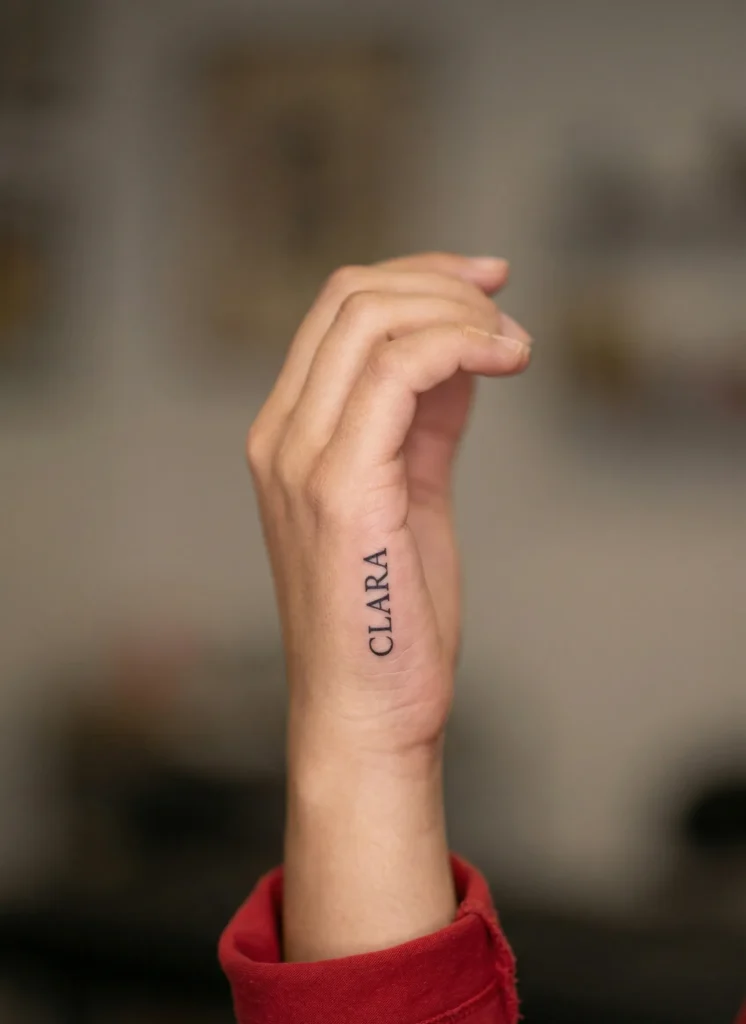 Small Name Hidden Tattoo on Finger Side