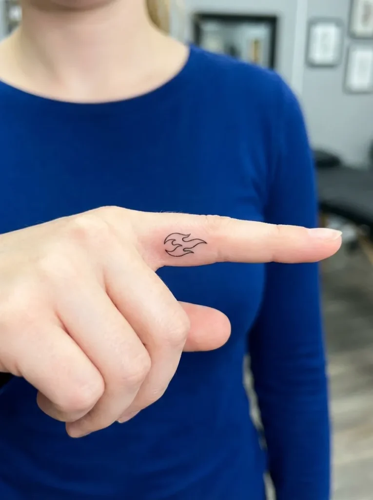 Tiny Flame Inner Finger Tattoo