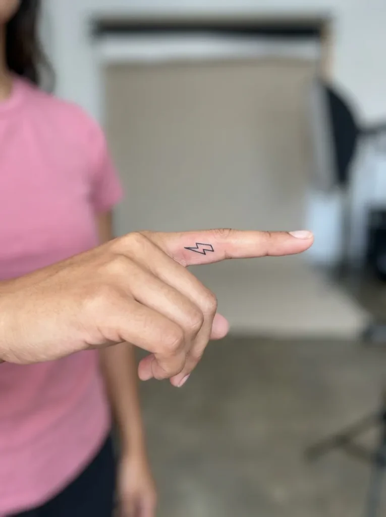 Tiny Lightning Bolt Inner Finger Tattoo