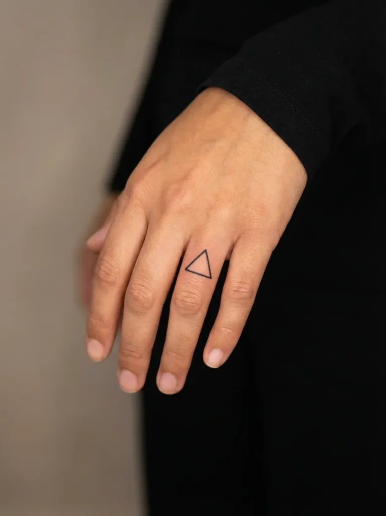 Tiny Triangle Inner Finger Tattoo